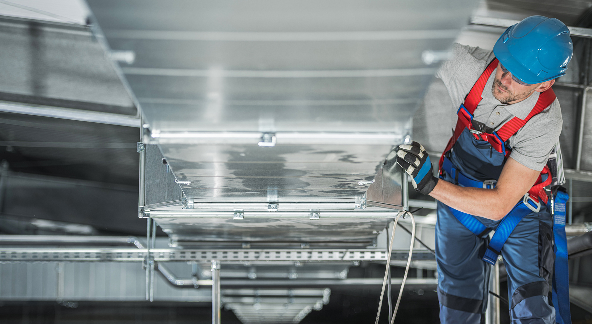 man looking at air con vent