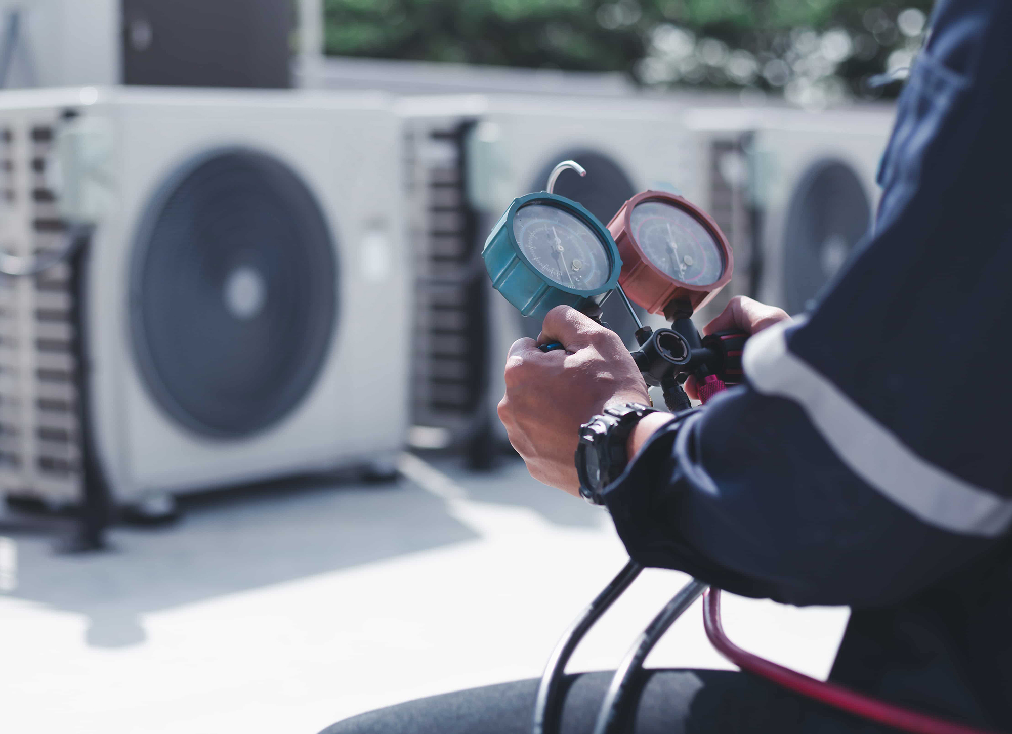 Technician is checking air conditioner ,measuring equipment for